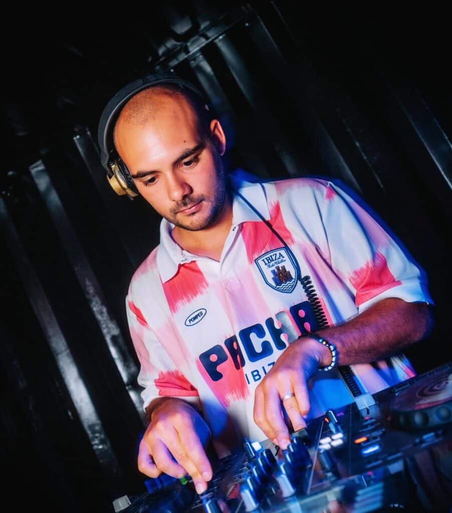 a man wearing headphones and a pink and white shirt